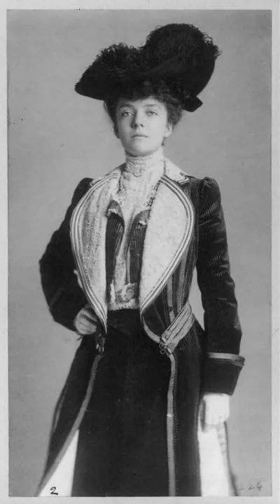 [Mrs. Alice Roosevelt Longworth, three-quarter length portrait, standing with right hand on hip, wearing coat and hat]