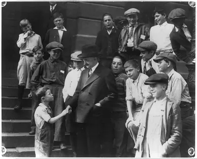 [Red" shaking hands with Judge Benjamin Barr Lindsey and telling him about a swimming hole on steps. Denver Colo.]"