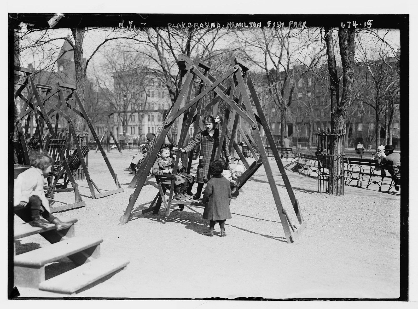 Children in playground swings, Hamilton Fish Park, New York, n/a — historic photograph