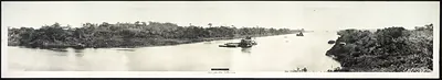 Panoramic view of a jungle river with a barge