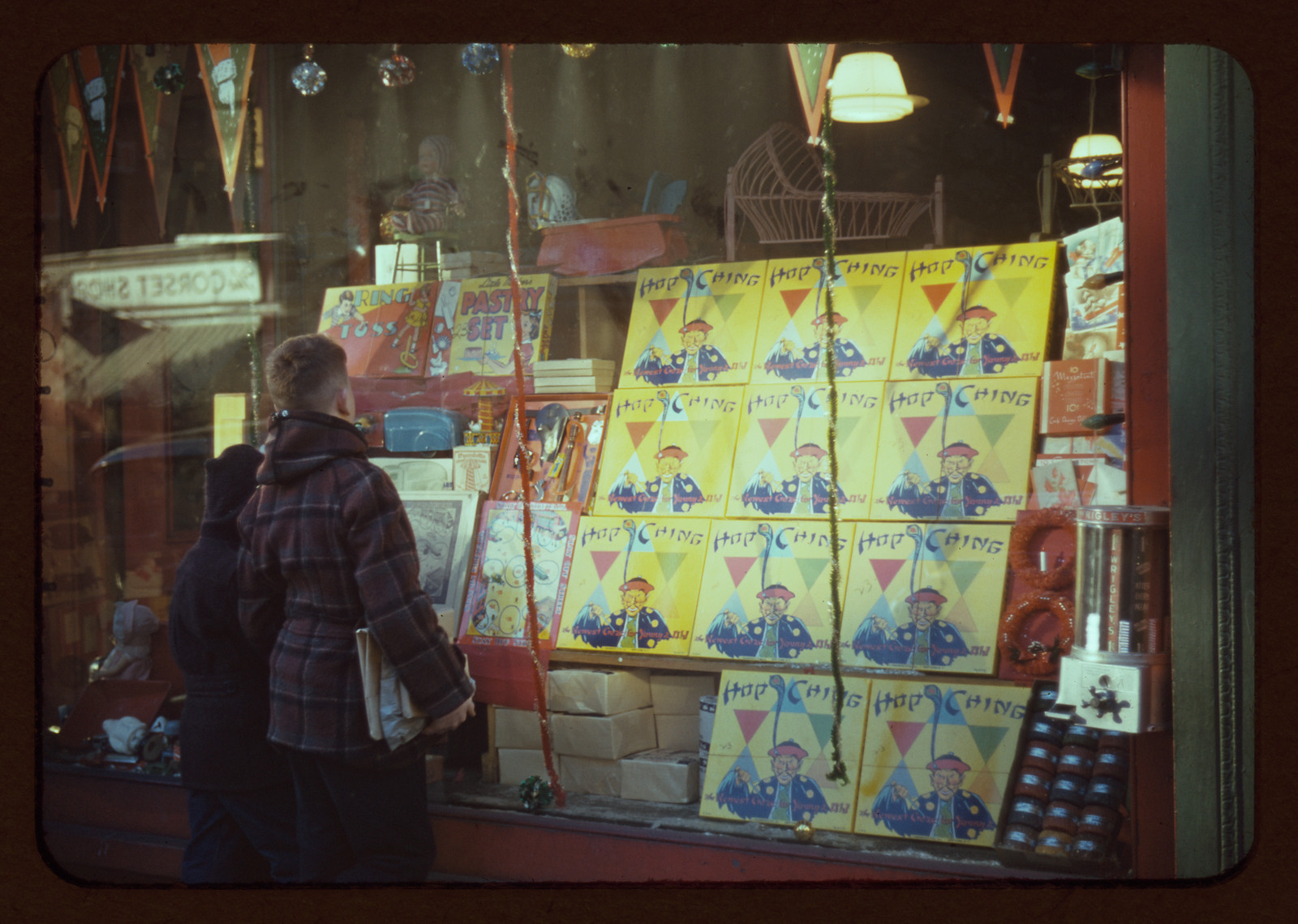 Shop window display of Hop Ching posters and decorations — vintage poster
