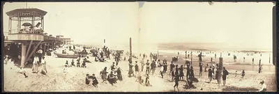 Panoramic view of crowded seaside beach with pavilion