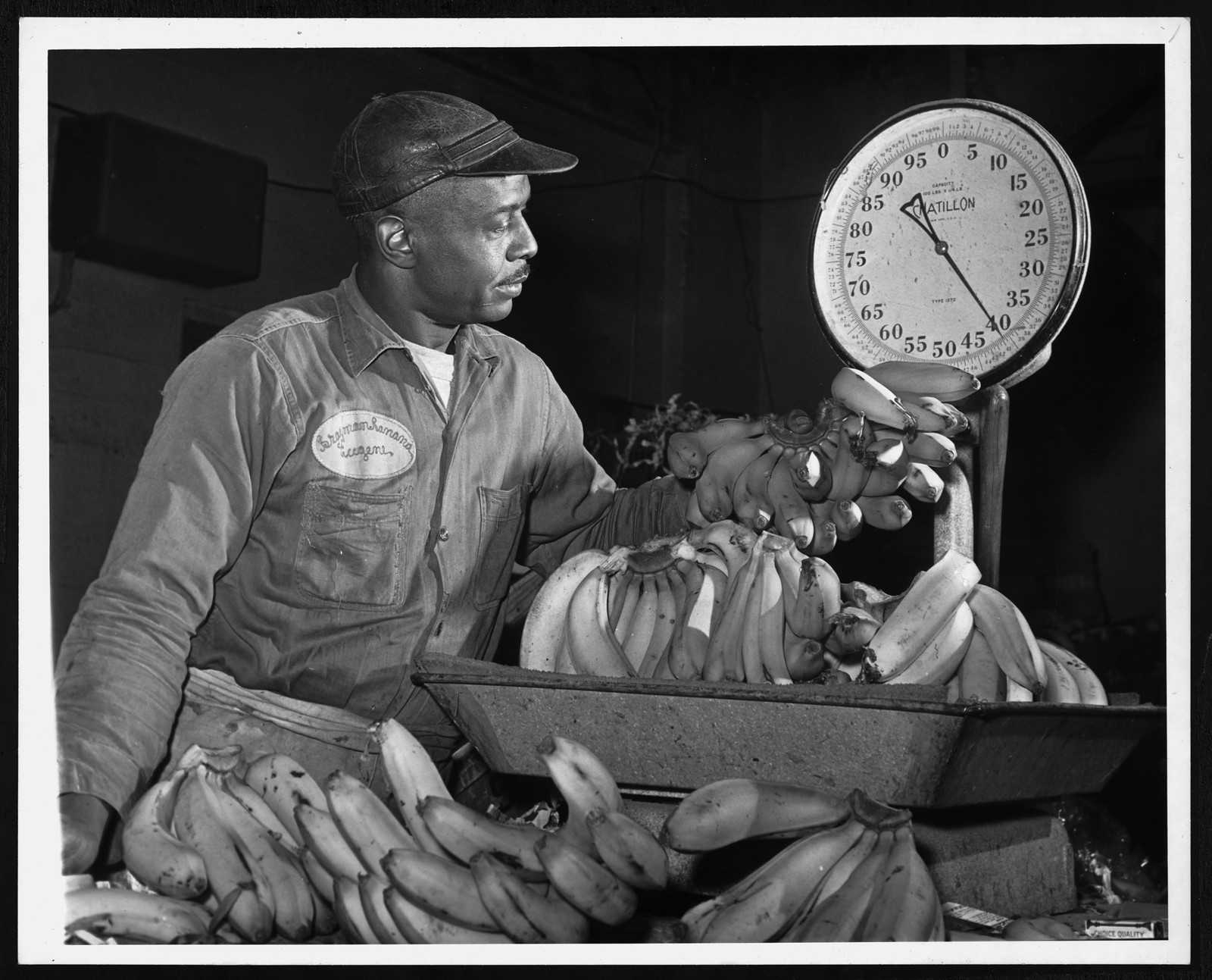 Man weighing bananas on a Chatillon scale — historic image