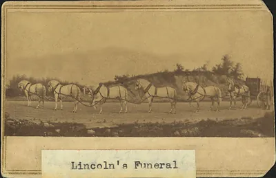 Six white horses drawing a hearse, labelled Lincoln's Funeral
