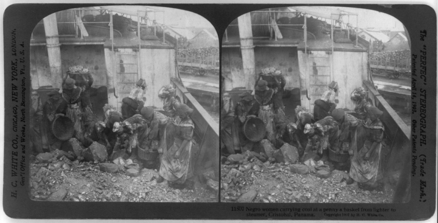 Negro woman carrying coal at a penny a basket from lighter to steamer, Cristobal, Panama, c1907. — historic photograph