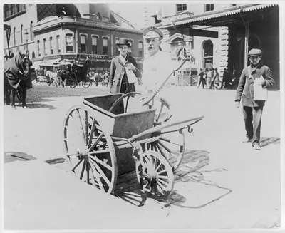 [New York City]: Street sweeper and handcart