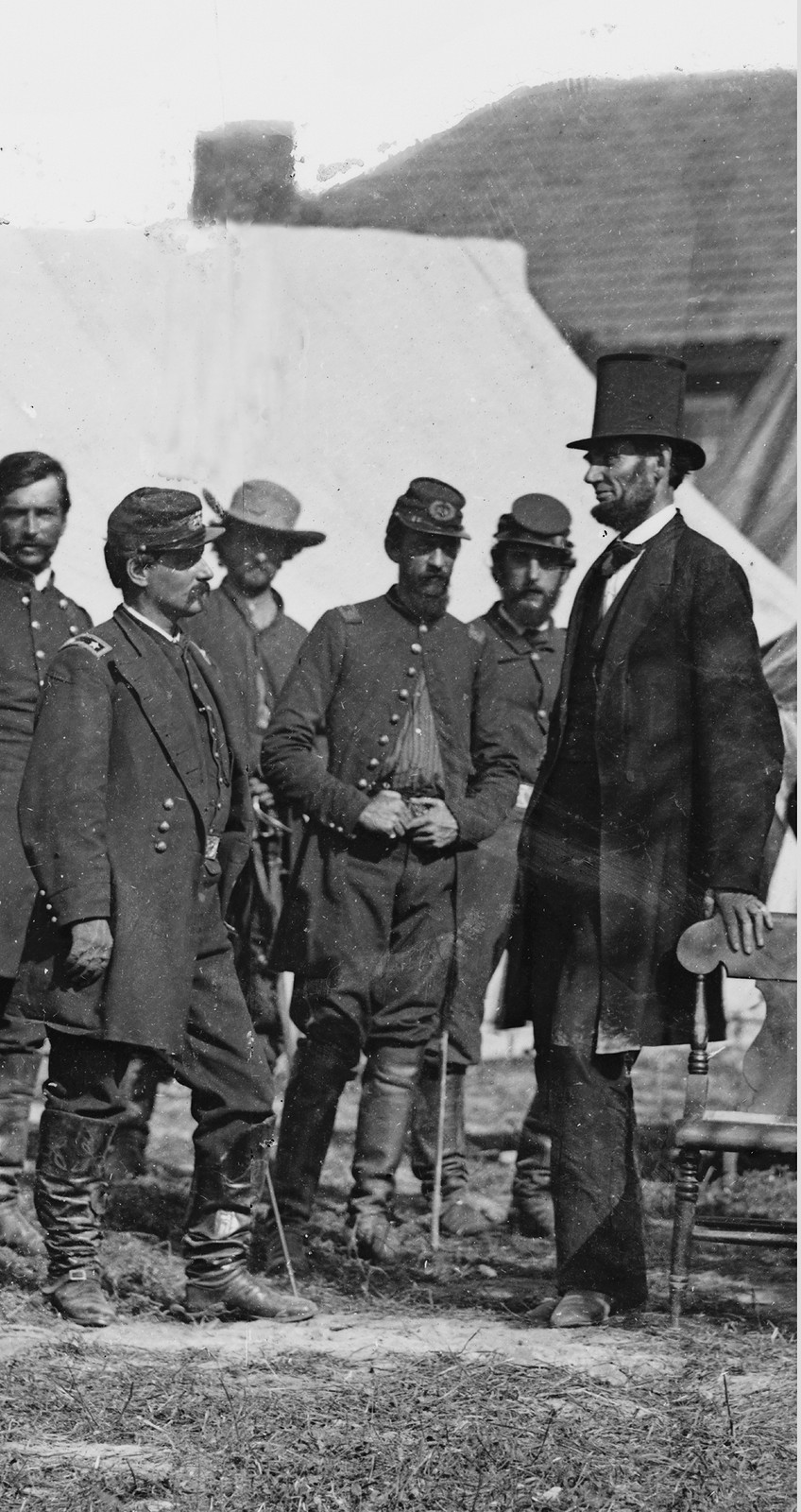 Man in top hat with Union soldiers outside a tent — historic image