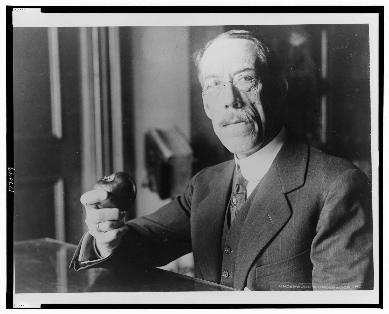 [Dr. William C. Fowler, half-length portrait, facing front, holding an apple] / Underwood & Underwood, Inc., 1926 February 6. — historic photograph