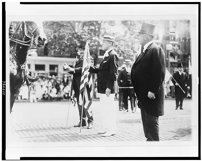 [Woodrow Wilson, holding U.S. flag, in parade, on Preparedness Day, Washington, D.C.]