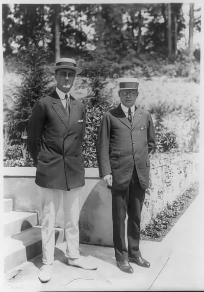 [Franklin Delano Roosevelt, full, standing, with unid. man]